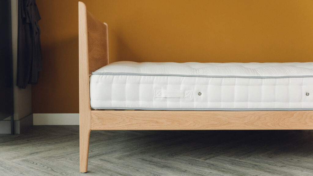 Oak Camden bed side view sprung mattress weldbank.