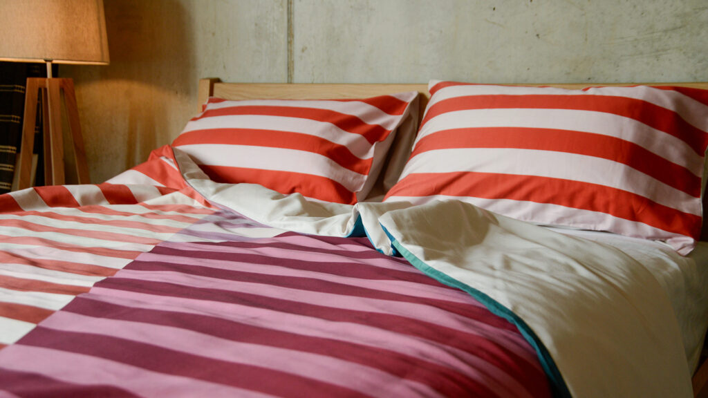 Colourful Stripe Bedding Rumpled with Pillows on Zanskar