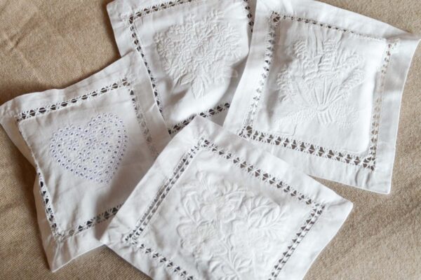 4 white embroidered lavender bags.