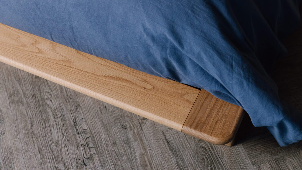 close up of the corner of the Portland bed's platform in oak.