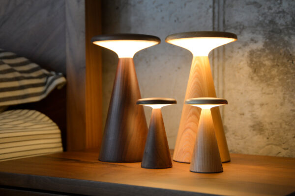 4 retro wooden table lamps. all lit in warm light.