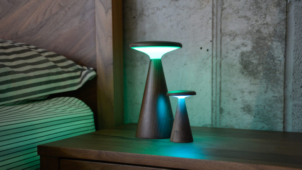 Retro wooden table lamps, one large, one small showing green light.