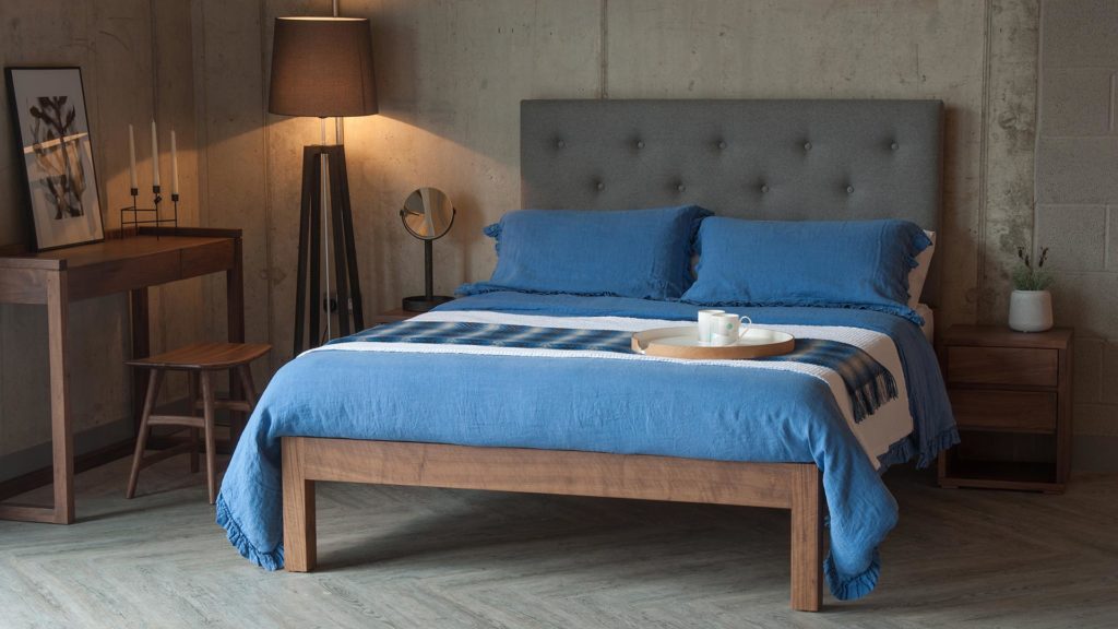 Skye bed with tall buttoned headboard blue linen bedding