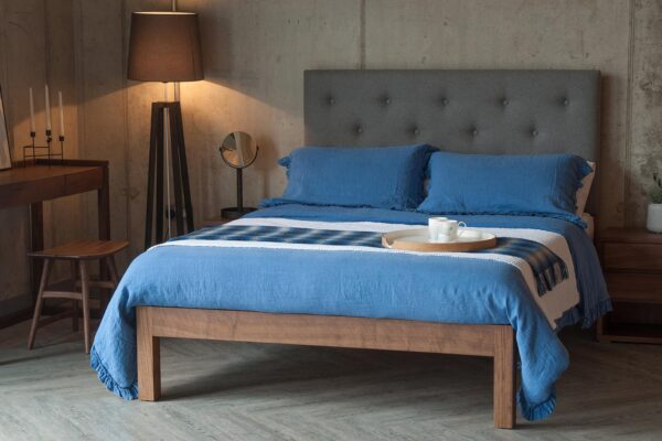Skye bed with tall buttoned headboard blue linen bedding