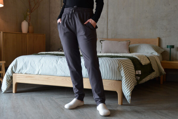 model wearing slim fit lounge pants with tie waist in charcoal.