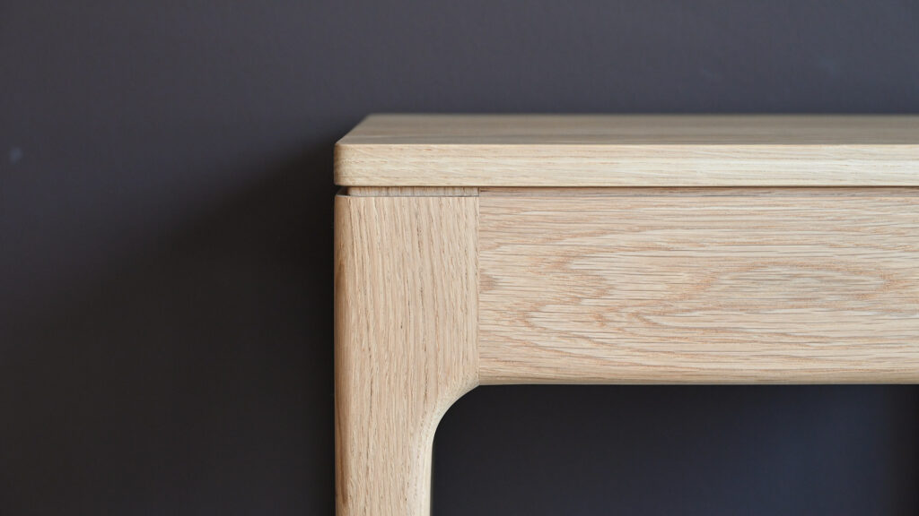 close up of grove detail on the corner of an oak bedside table - Camden style.