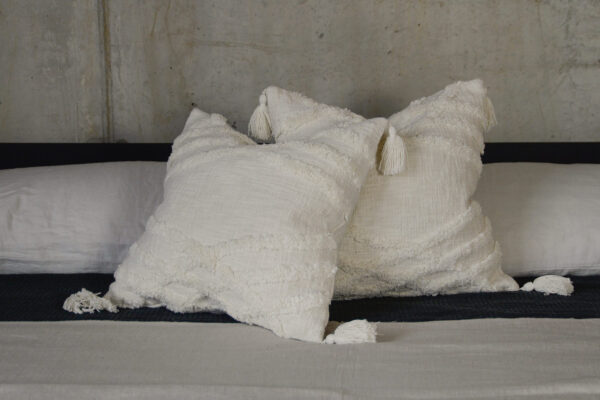 Tasseled Tufted Ecru Cushions with monochrome bedding