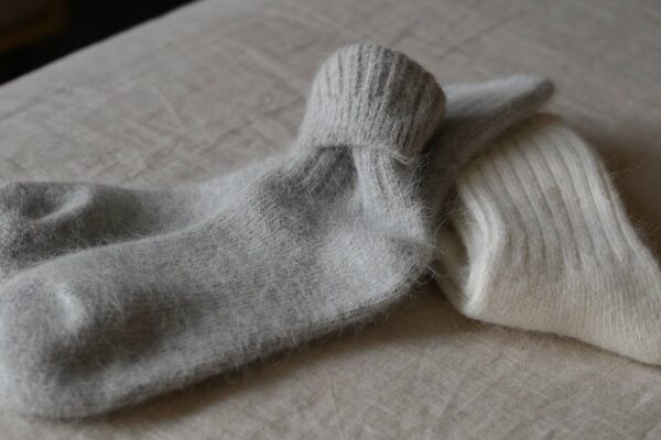 2 pairs of Angora blend socks with rib top. One pair ivory, the other grey.