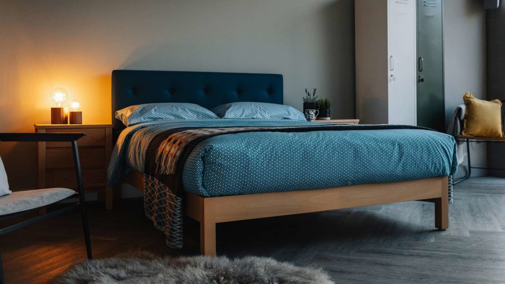beech Arran bed with teal headboard and beding