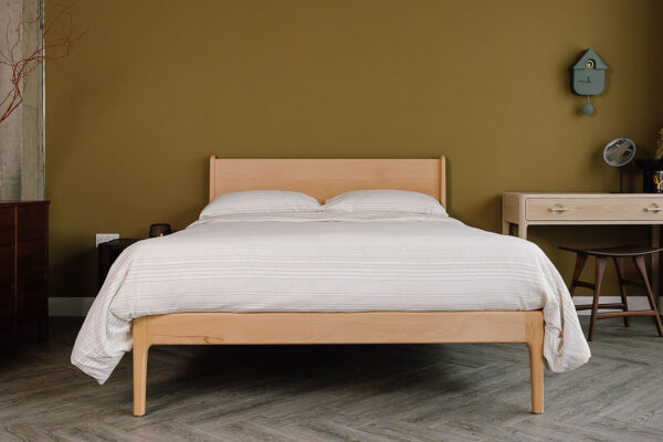 Beech Camden bed with textured bedding set. Room set with white oak desk, Ethnicraft teak stool and accessories.