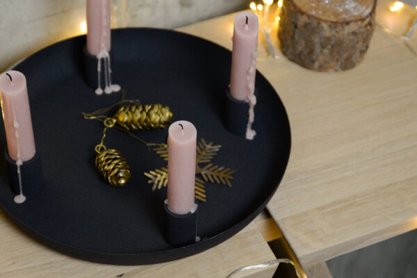 black bowl candle holder from above pink candles