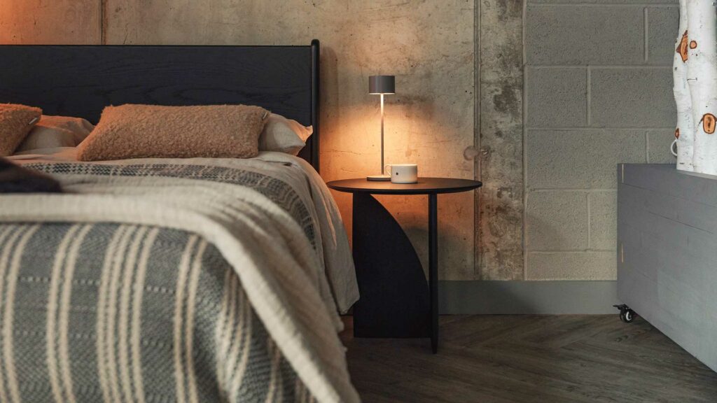 black geometric side table with black camden bed