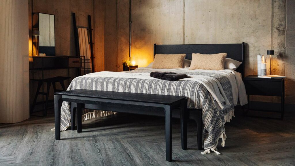 black oak furniture with luks bedspread and faux sheepskin cushions