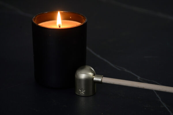 brass colour candle snuffer with wooden handle