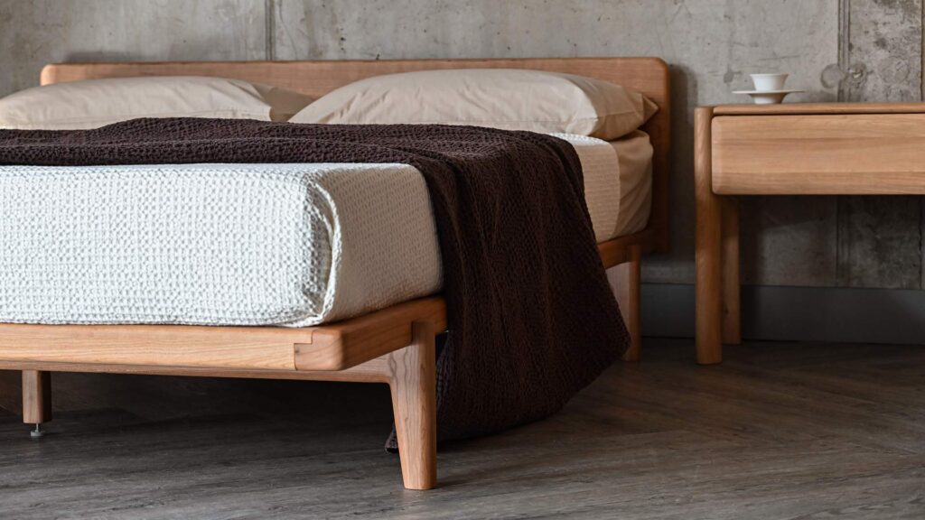 An espresso brown waffle textured bedspread on a solid cherry Osaka bed base.