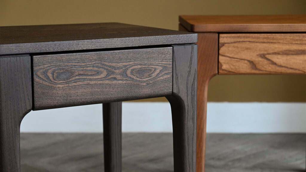 Detail of corner of Camden Drawer Table in cool smoked ash, with warm smoked ash version in background.