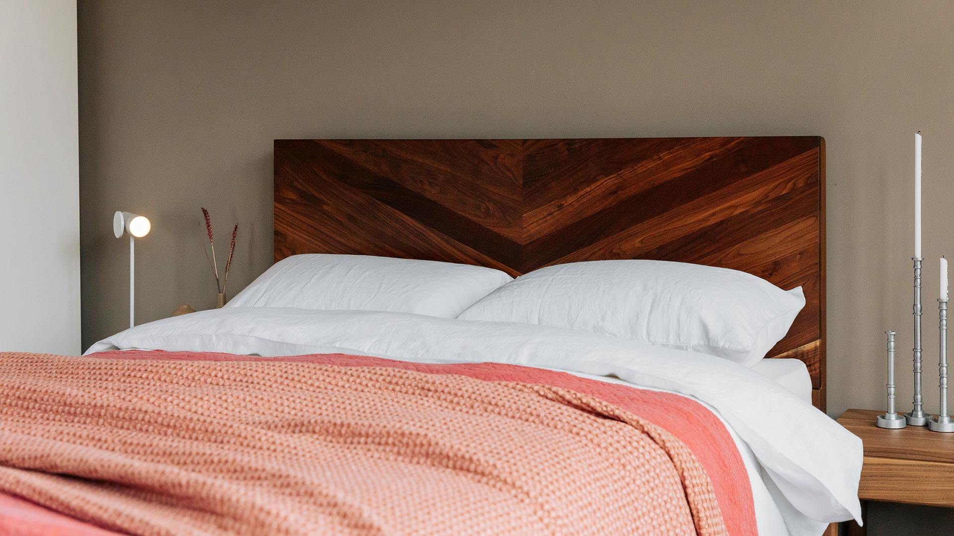 coral bedding on oiled walnut bed