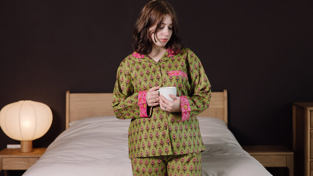 model wearing green and pink printed pjs.