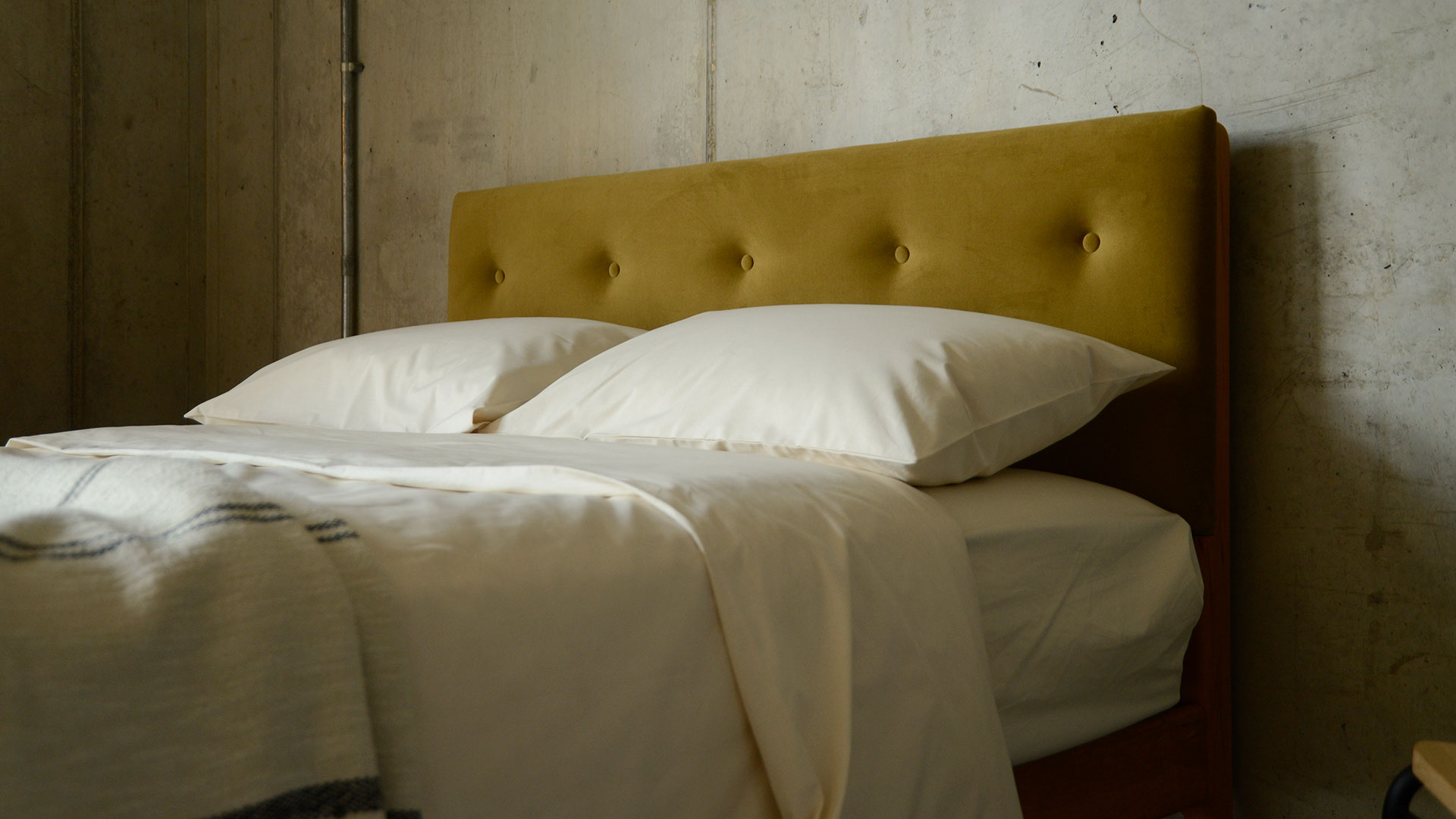 eco velvet upholstered headboard with organic cotton bedding
