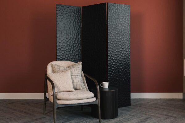 ethnicraft screen with boucle lounge chair and roller side table