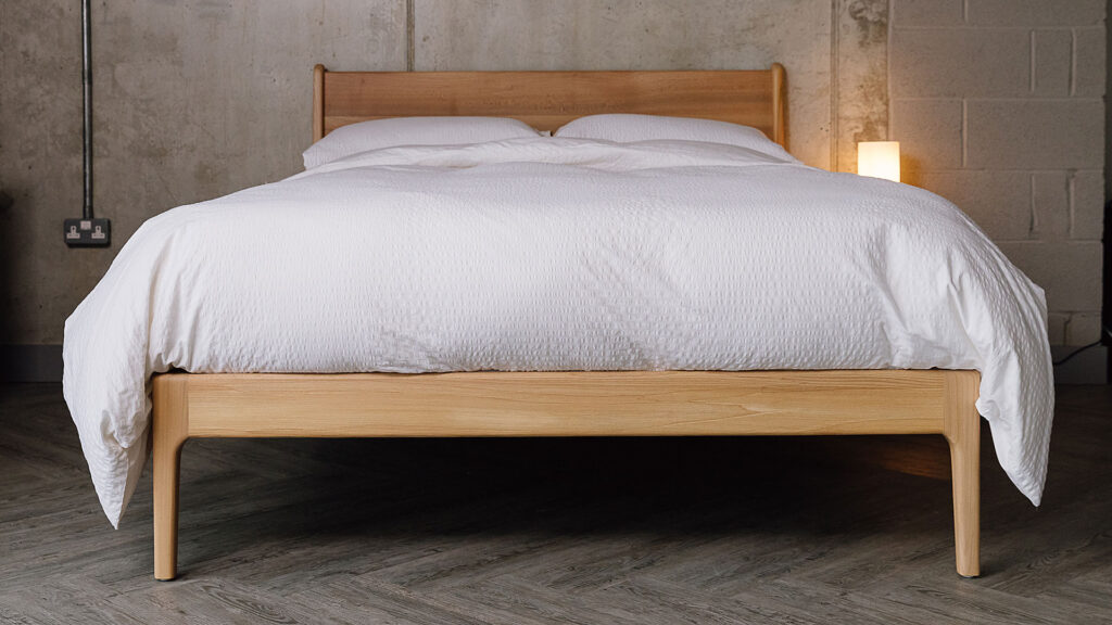 White seersucker bedding set on Scottish Elm Camden bed. Front view.