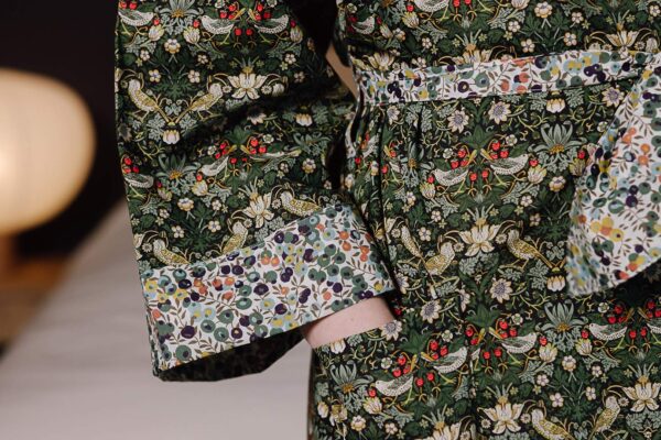 close up of green liberty print dressing gown with lighter cuffs.