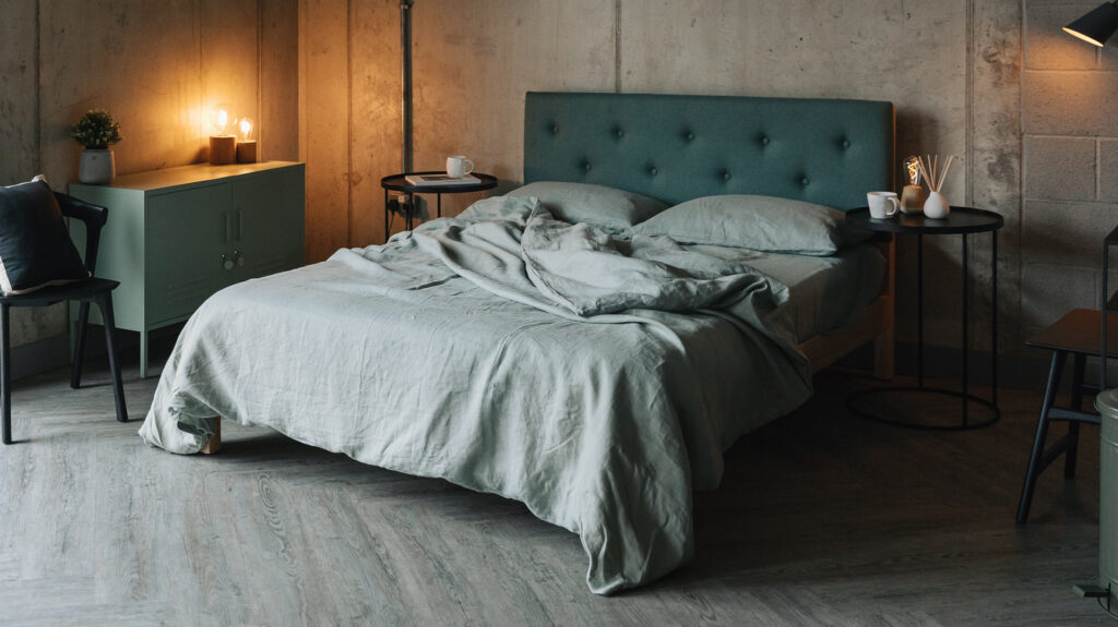 green organic linen bedding on Arran bed with Ethnicraft side tables