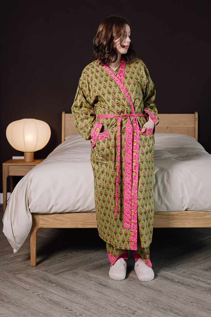 model wearing green and pink floral pjs with matching robe.