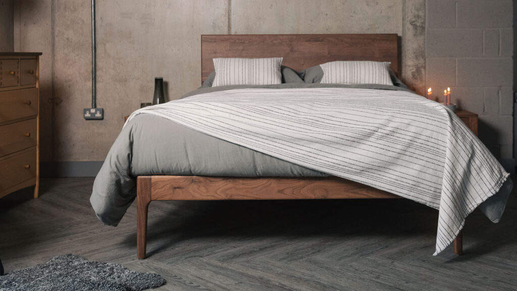grey and white striped bedding on walnut Chiswick