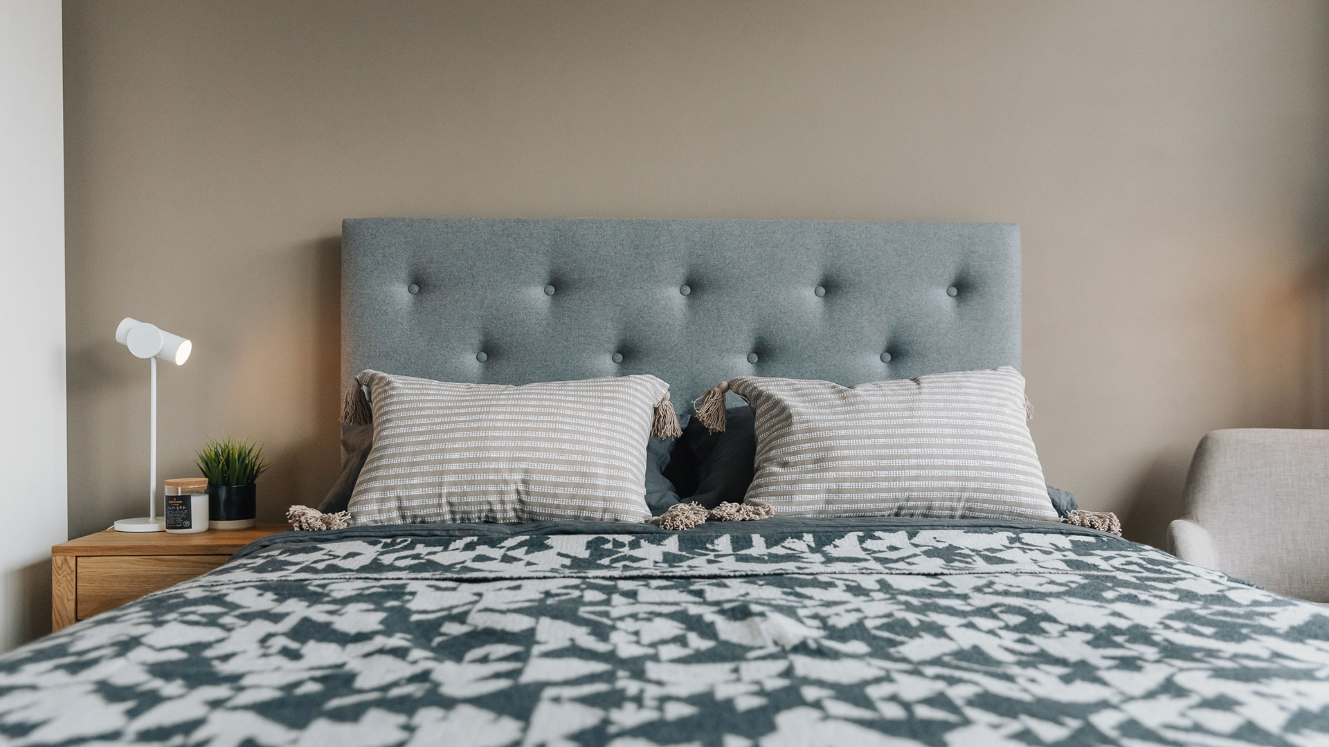 grey sKye headboard with taupe striped cushions