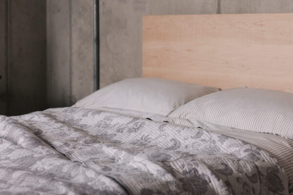 grey striped bedding and floral bedspread