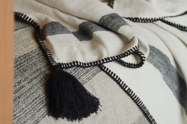 ivory and black throw with tassle detail