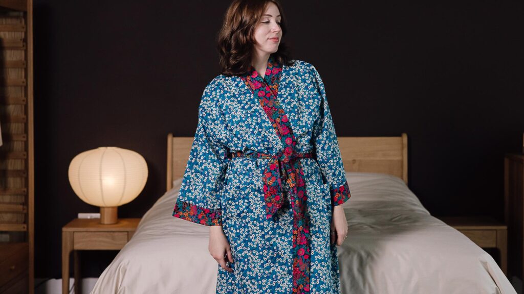 Model wearing blue liberty print robe with rem cuffs and tie.