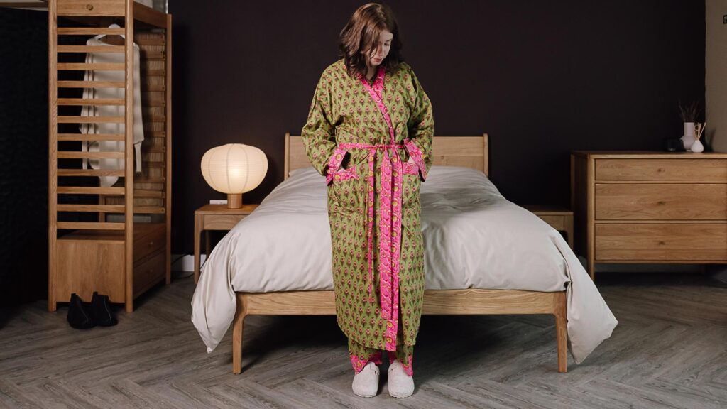 model wearing green and pink floral pjs with matching robe.