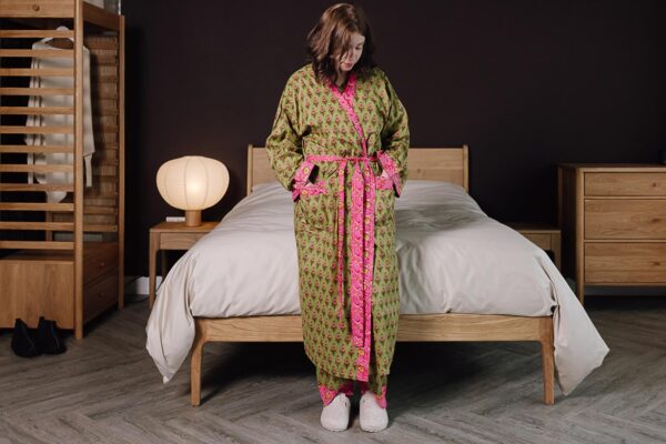 model wearing green and pink floral pjs with matching robe.