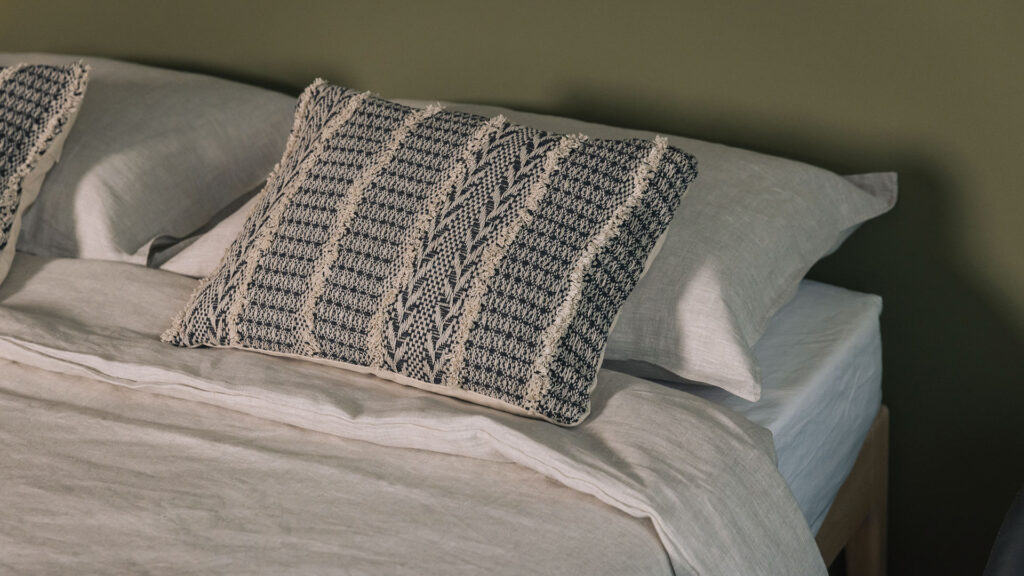 linen bedding with boho cushion on camden without a headboard.