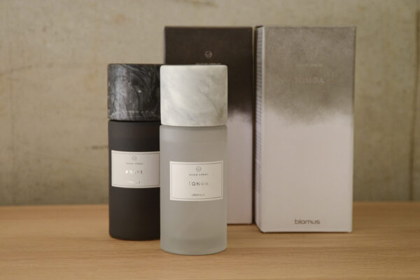 Tonga and Agave room sprays in glass bottles with marble lids.