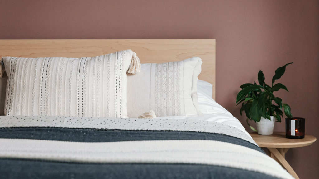 malax embroidered cushion on maple Malabar bed