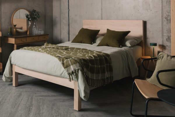 maple Bamford bed with olive green check throw
