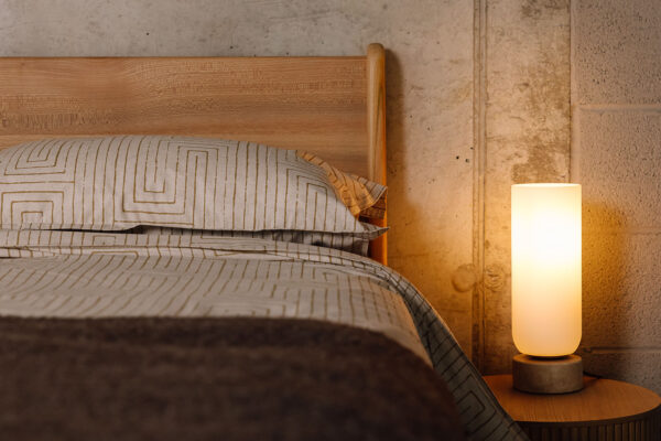 Gold grid pattern duvet set on Scottish Elm Camden bed with soft diffuse lamp on bedside table.