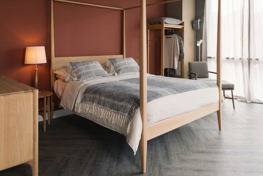 mid century look oak four poster bed with grey and ivory bedding