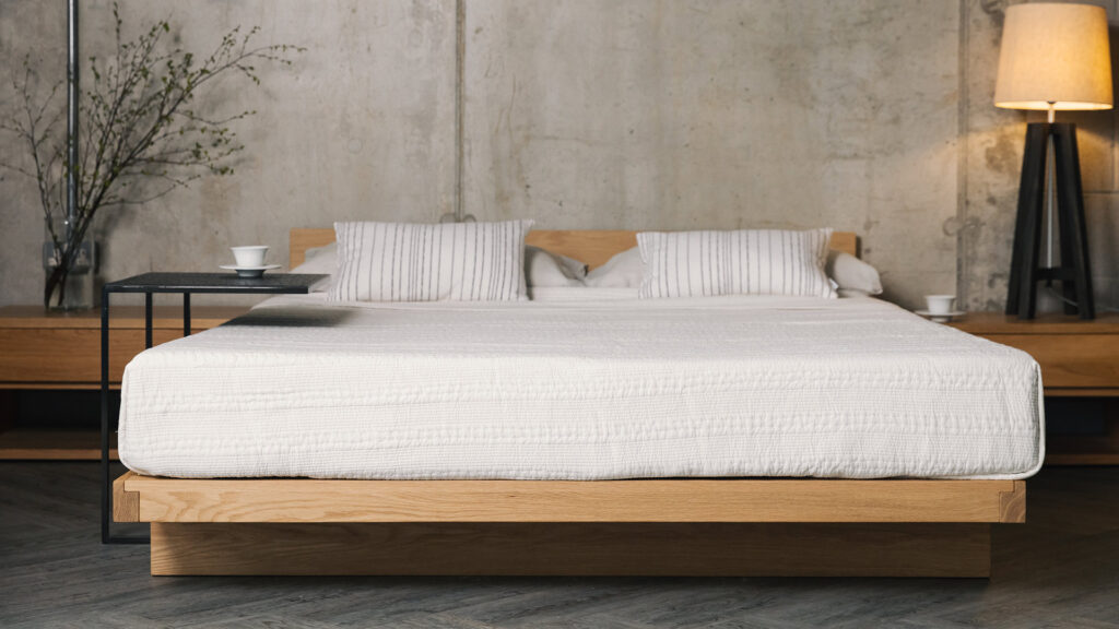 oak Kumo low bed with white kantha bedspread