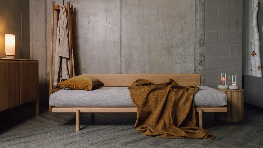Oak Osaka daybed with mustard cushion and throw.
