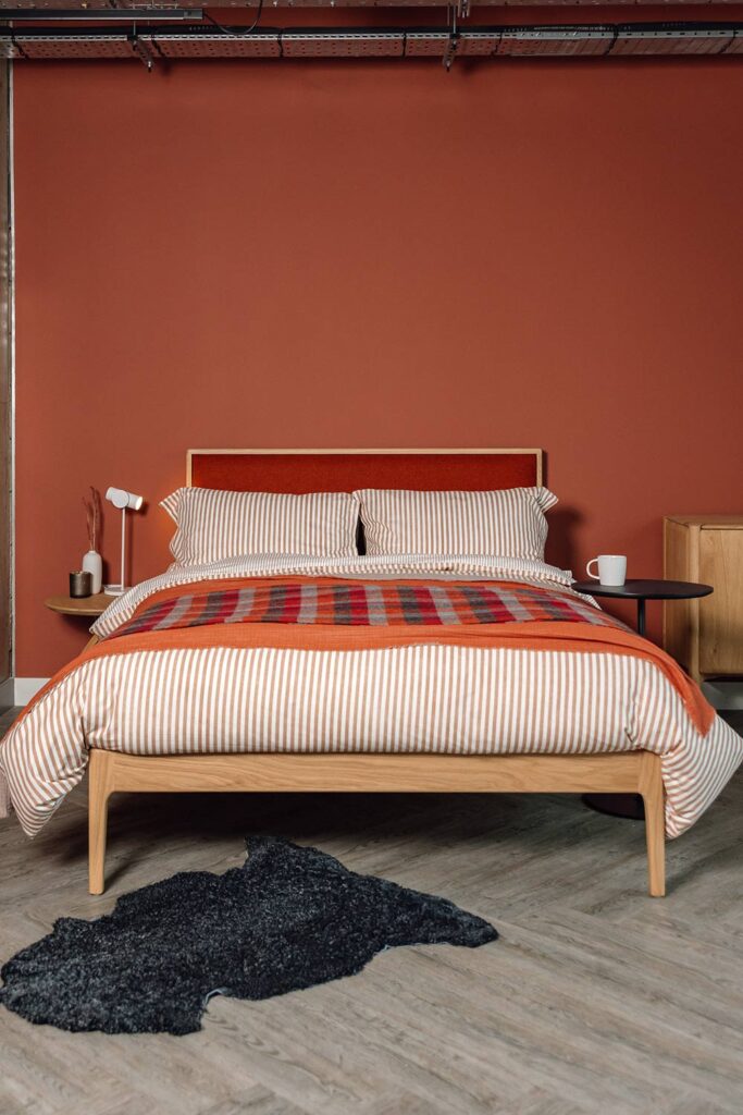 oak carlisle bed with red headboard panel portrait 1