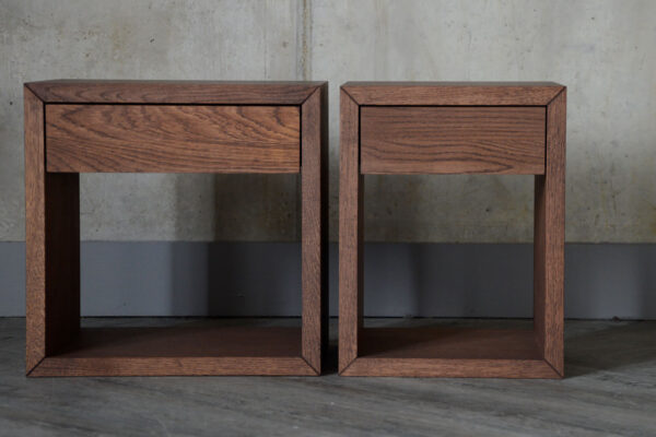 Front view of the two different options for the wall mounted nightstands. The units are slightly different widths, with the one on the right being completely square, and the one on the left being narrower, a more rectangle shape.