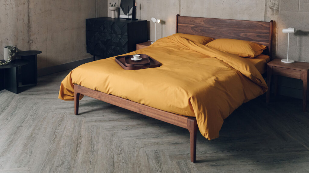 oiled walnut c amden bed with ochre colour cotton bedding
