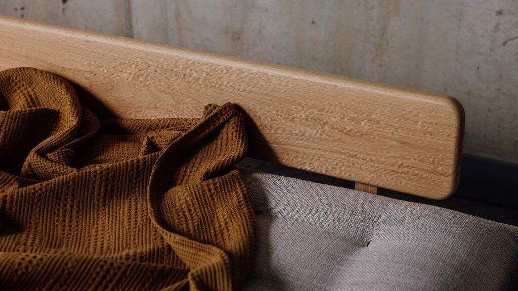 Close up of oak backrest on daybed.