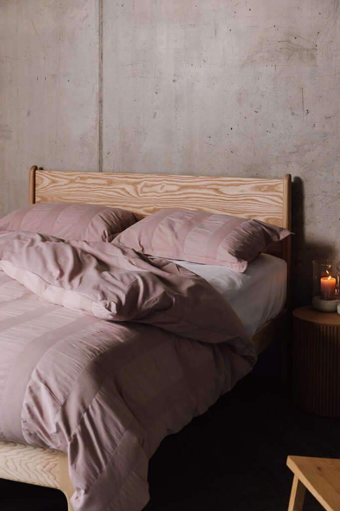 rumpled pink cotton duvet set on a solid ash Camden bed.