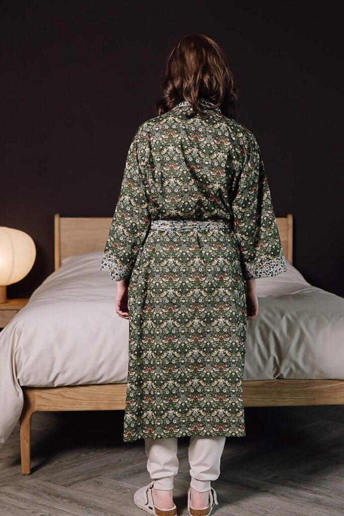 Model wearing liberty print robe in green and ivory.