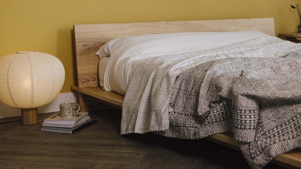 Grey kantha bedspread with wave pattern on ash Oregon.